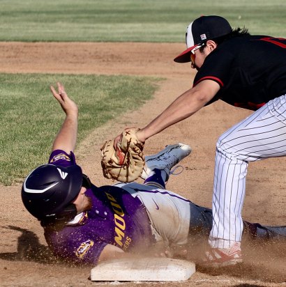 Lemoore's Jack Ferguson dives back to first.